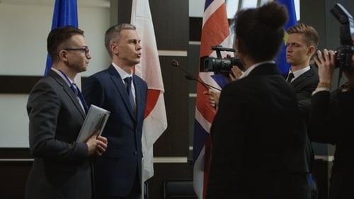 Man in Suit Speaking at Corporate Conference