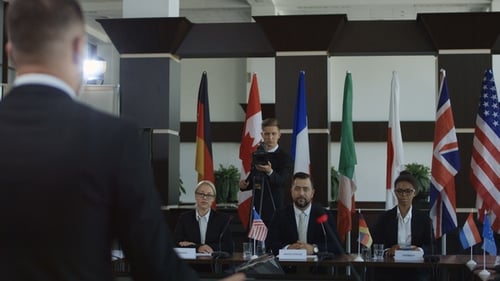 International Business Meeting With Flags and Professionals