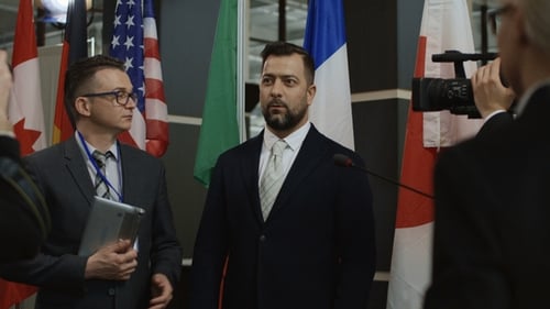 Formal Press Conference with Flags and Businessmen