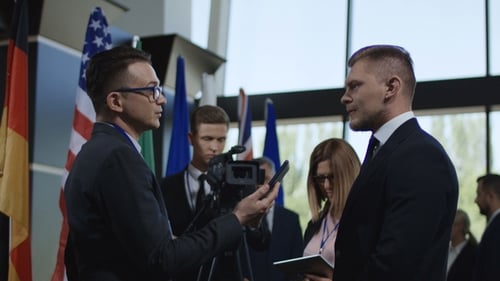 Man Receives Interview at Press Conference Event