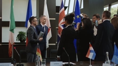 Press Conference with Flags and Journalists Present