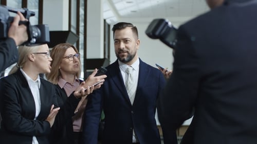 Man Answering Questions at Press Conference