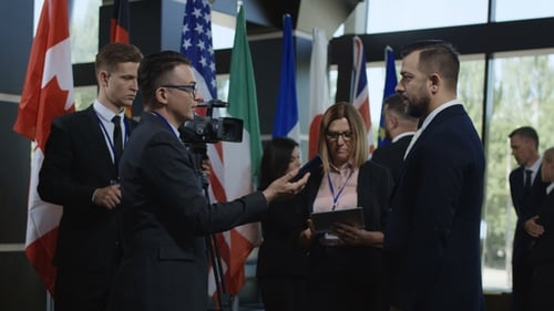 Man Being Interviewed with Flags at Political Conference