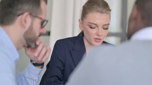 Rear View of Young Male and Female Business People Talking