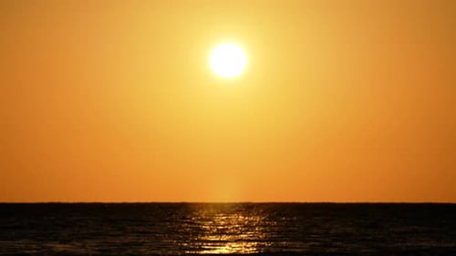Dramatic Orange Sunrise Over the Beach. Red Sky, Yellow Sun and Amazing Sea. Summer Sunset Seascape