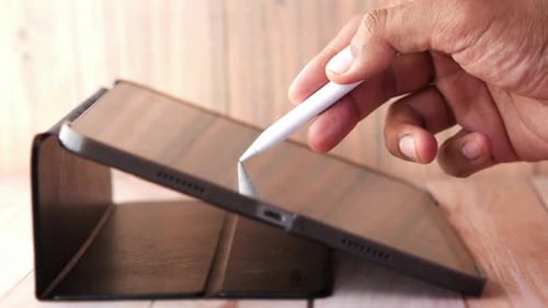 Hand Using Stylus on Digital Tablet Device