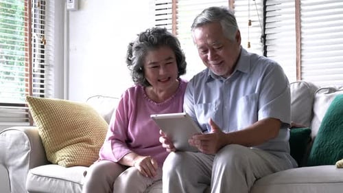 Senior Couple Using Tablet at Home Together