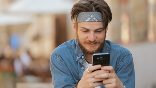 Man Using Smartphone in Urban Setting