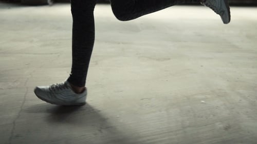 Legs Running on City Street