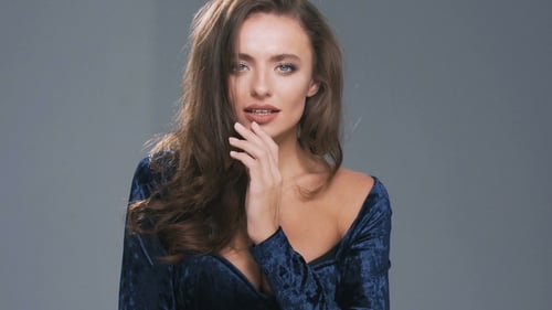 Gorgeous Woman Model with Curly Hair Posing at Isolated Gray Background in Studio