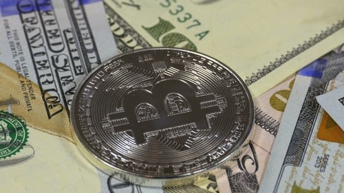 Silver Bitcoin Coin BTC and Bills of Dollars Are Rotating