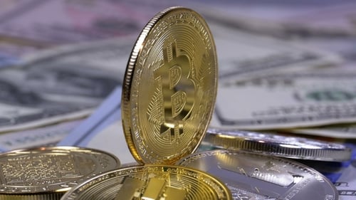Gold Bitcoin Coin Macro Shot on Dollar Bills