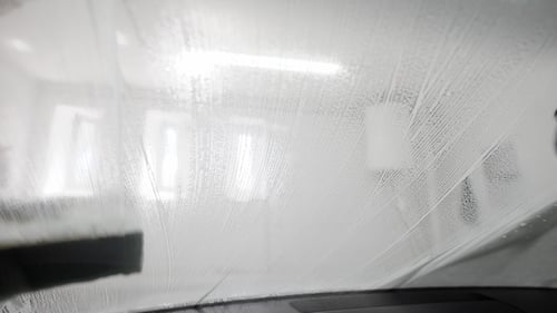 Cleaning Car Window with Brush and Soapy Water