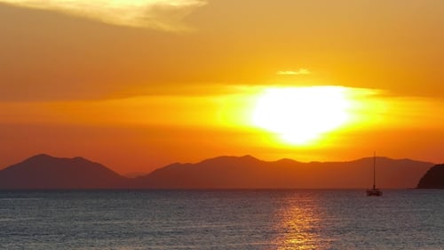 Long Tail Boats in the Sea at Sunset