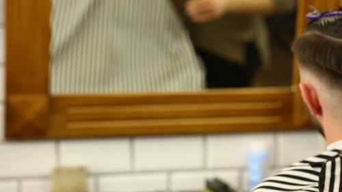 Barber Styling Hair in Barber Shop