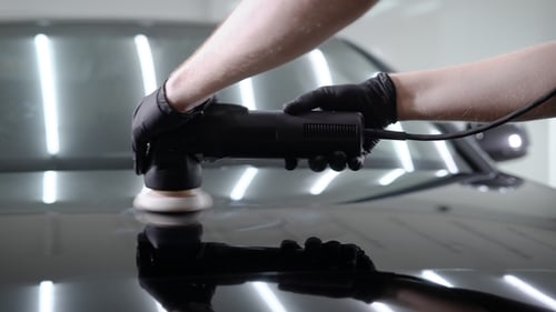 Shot of a Man Waxing Hood of the Car with Special Tool.