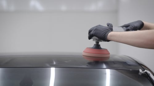 Auto Detailing with Power Buffer in Garage