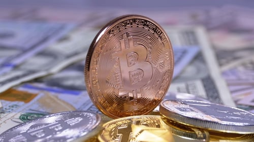 Bitcoin and Cryptocurrency Coins Stacked on US Dollars