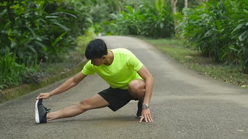 Man Runner Stretching Legs Before Run