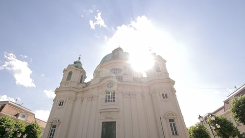 Lower Point of Wide View of the Old Beautiful Catholic Church With Sun Glare and Sky in Background