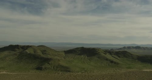 Helicopter aerial shot close to fields and highway, overcast day