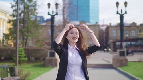 Happy Businesswoman Is Walking and Dancing in the Street Looking at Camera. Happynes. Celebrate