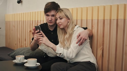 Young Couple Looking at a Phone Together