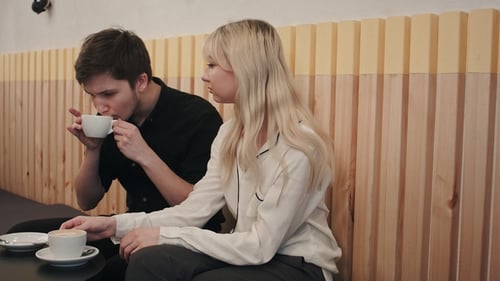 Young, Beautiful Couple Having a Date in Cafe, Talking and Drinking Coffee