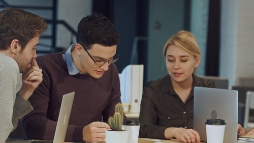 Young Business People Discussing in Meeting Room at Creative Office