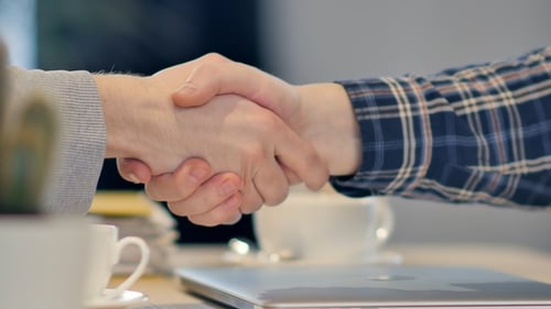 Successful Business Handshake in Bright Modern Workplace