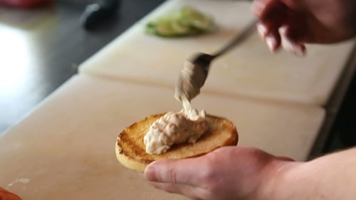 Spreading Sauce on a Toasted Burger Bun