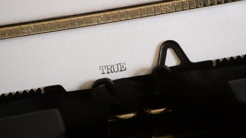 Typewriter Types the Word True on Paper