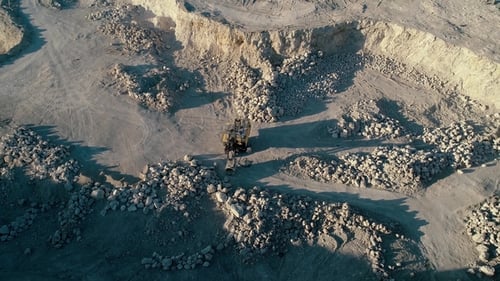 Drone Aerial Footage. Fly Around Excavator in a Mountain Stone Quarry