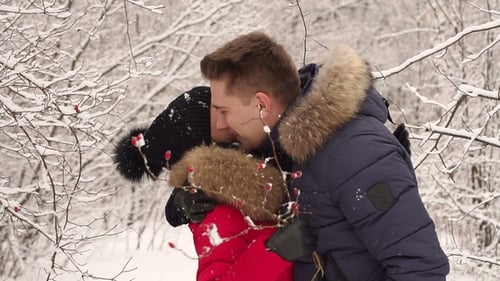 Portrait of a Couple in Love in the Winter Forest
