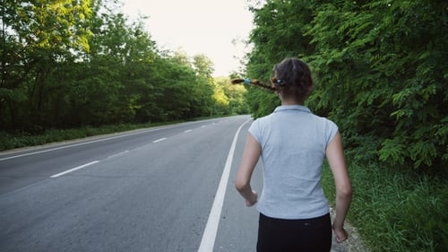 Woman Runner Running on Open Road in Countryside