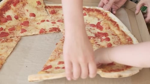 Grabbing Delicious Tomato Pizza Slices in a Box