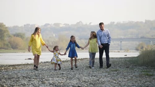 Family walking by a river
