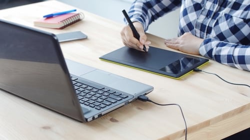 Artist Using Graphic Tablet at Desk