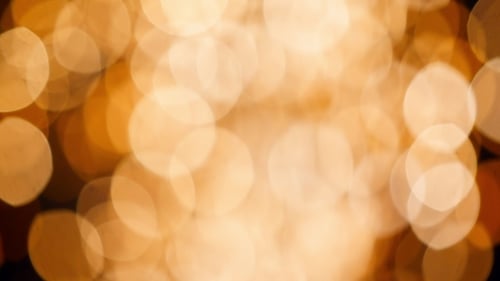 Motion Background of Blurred Circle Bokeh Gold Rain Fireworks Lights During New Year Holiday