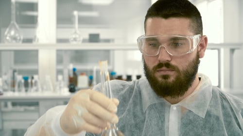Close Up of Scientist Examining Bubbling Liquid in Lab