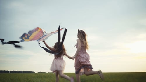 Girl Running Around with a Kite on the Field. Freedom Concept.