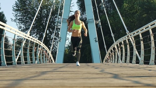 Active Woman Jogging Running on City Footbridge