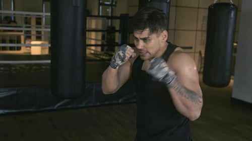 Male Boxer Shadowboxing in Gym