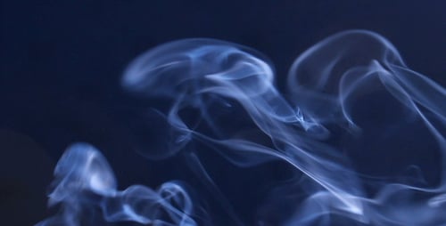 Light Blue Smoke Rising on a Dark Background