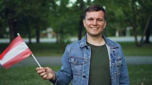Smiling Man Waving Red and White Flag
