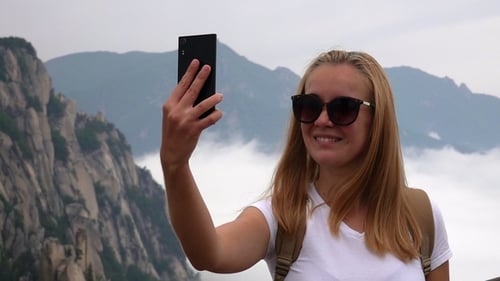 Caucasian Female Tourist Taking Selfie with Ulsanbawi Rock. Mountain in Seoraksan National Park