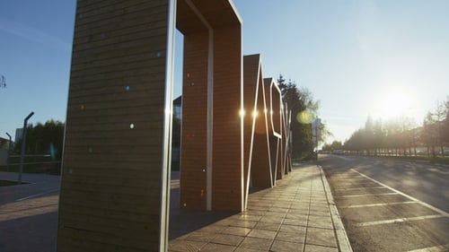Motion Aside Past Large Beach Sign at Sun Rays