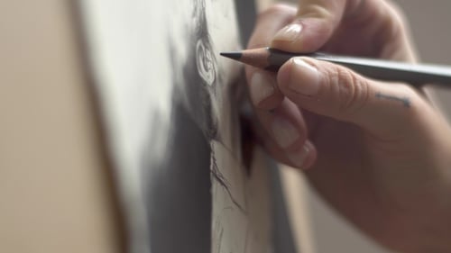 Hand Drawing a Portrait on Canvas Close Up