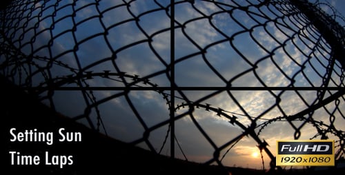 Barbed Wire Fence with Sunrise in the Background