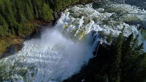 Majestic Waterfall Cascading Through Lush Forest, Aerial View